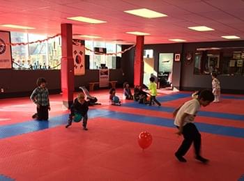 Young children participating in taekwondo coordination drills on high-quality martial arts mats to improve agility.